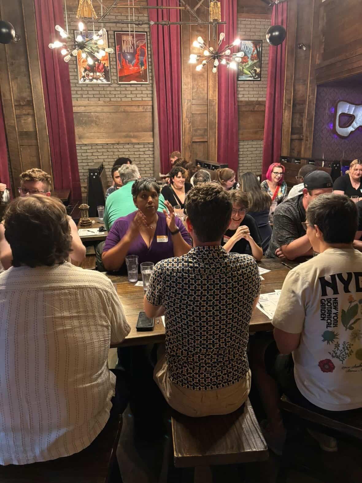 Critical Match guests talking in small groups at a Connection Quest.