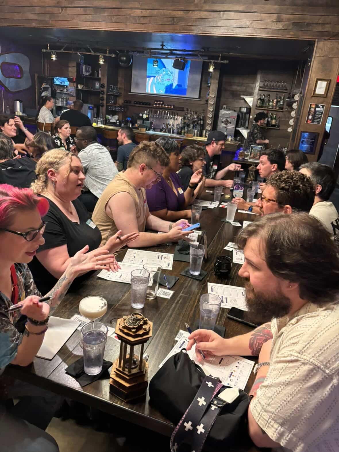 Critical Match attendees filling a venue table during a flagship event.